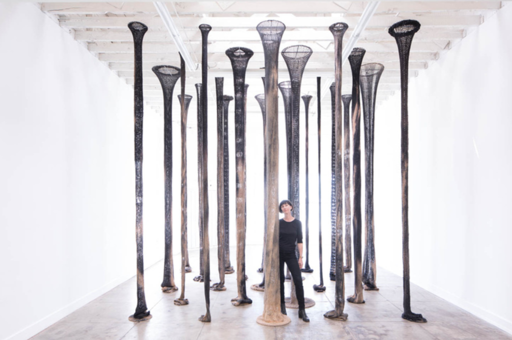 Claudia Parducci standing in her installation, 23 Columns