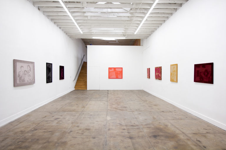 Installation image for Yasmine Nasser Diaz's Soft Powers show, of about eight fiber etched works hanging on the wall of the gallery.