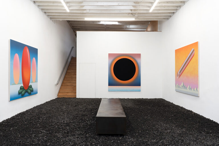 Installation image of Ben Sanders's Deep Time at OCHI, Los Angeles, CA. Various paintings installed on the wall above a floor of lava rocks. There is a dark metal bench in the center of the gallery.