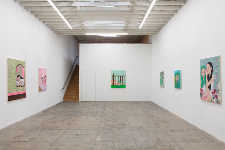 A group of paintings installed on the gallery walls.